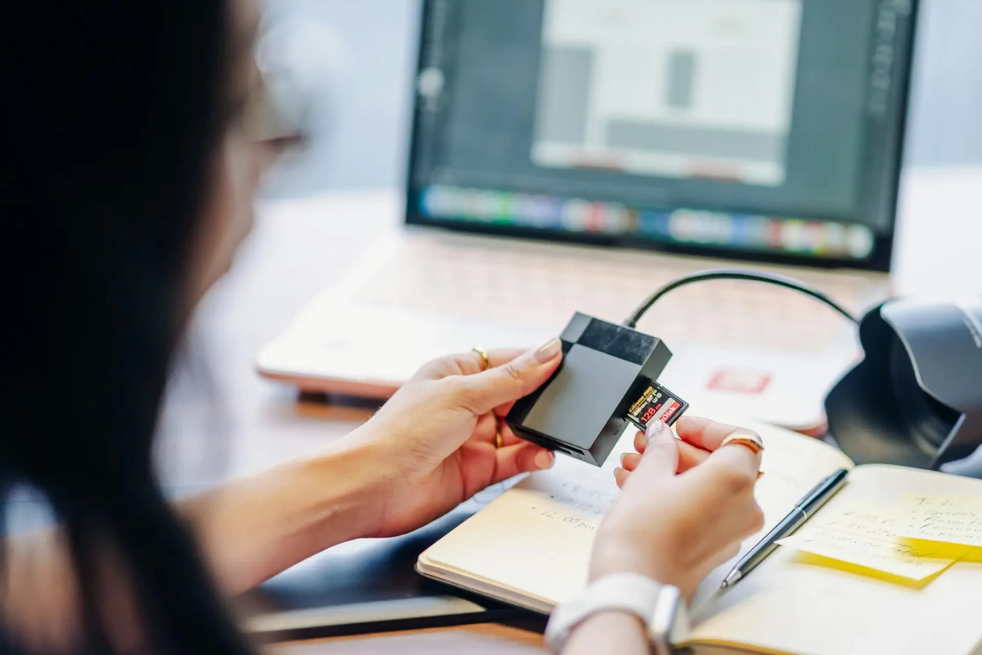 Illustration of a woman inserting a SD card into a card reader