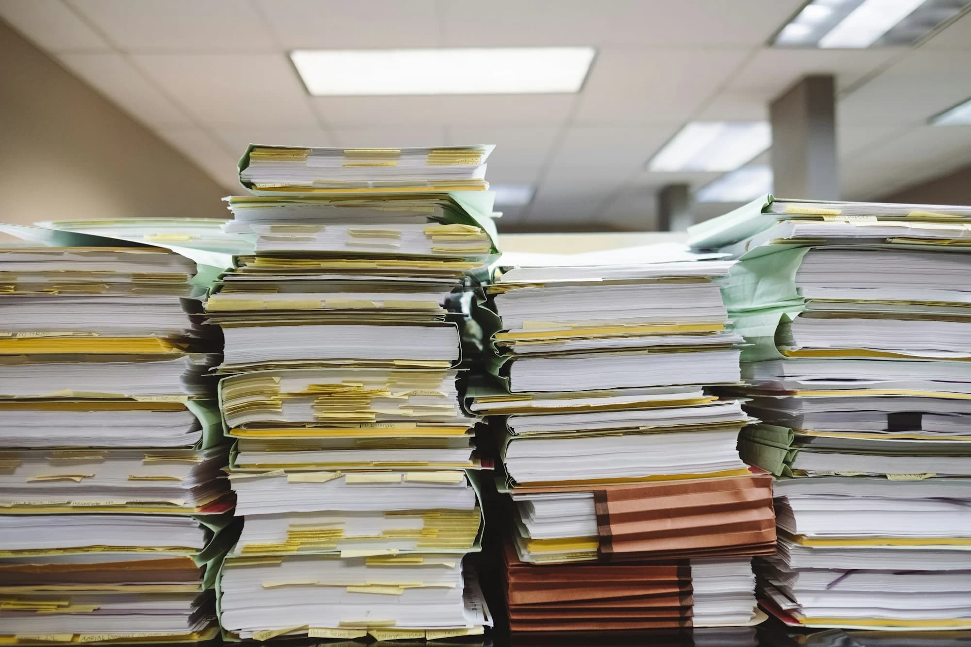 Stack of books on a table (Wesley Tingey, Unsplash)