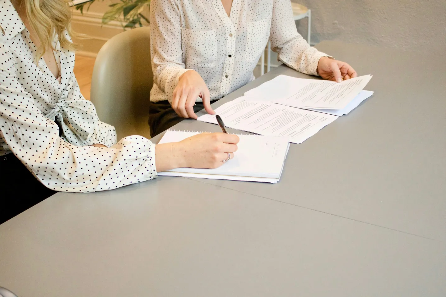 Woman signing a white paper